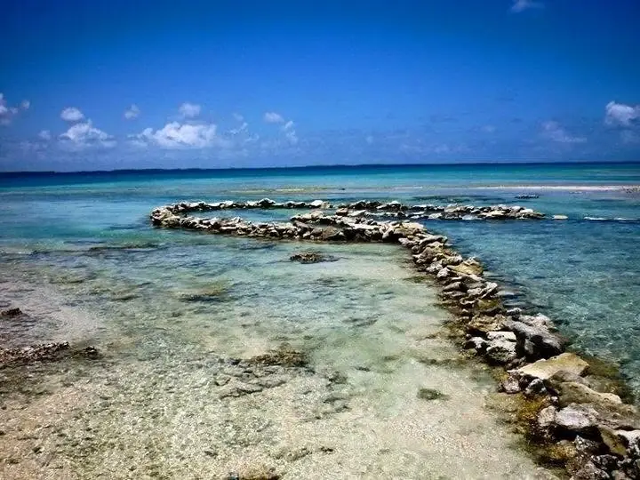 Un ancien parc à poissons en blocs de corail, dans l'eau peu profonde